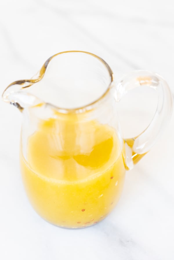 Champagne vinaigrette in a glass pitcher.