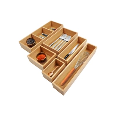 A set of wooden drawers with kitchen drawer dividers to organize utensils and silverware.
