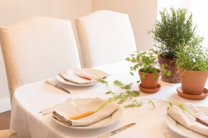 A set dining room table with easter flowers for a centerpiece. 