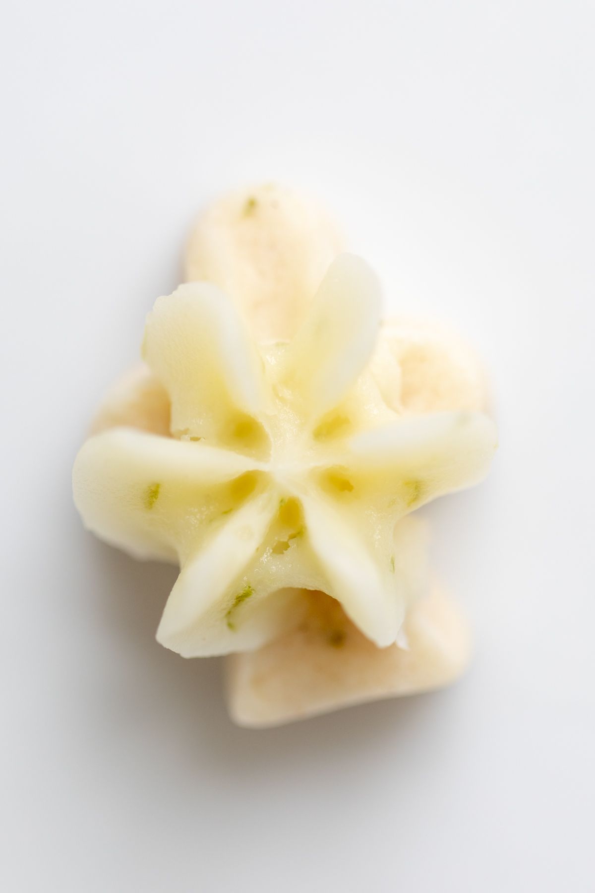 A frosted lime cookie on a white plate