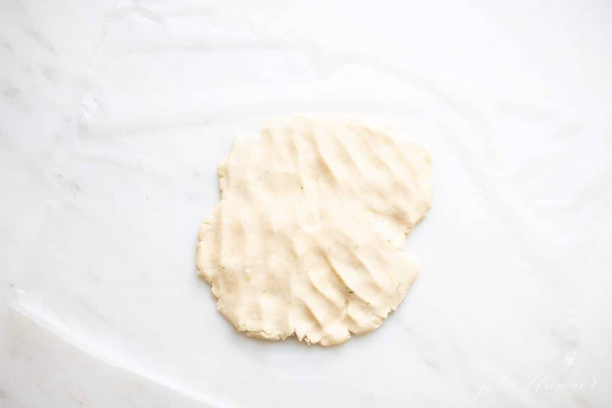 A flat disk of lime cookie dough.