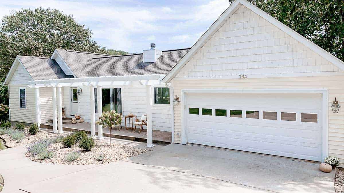 white ranch house with an attached pergola