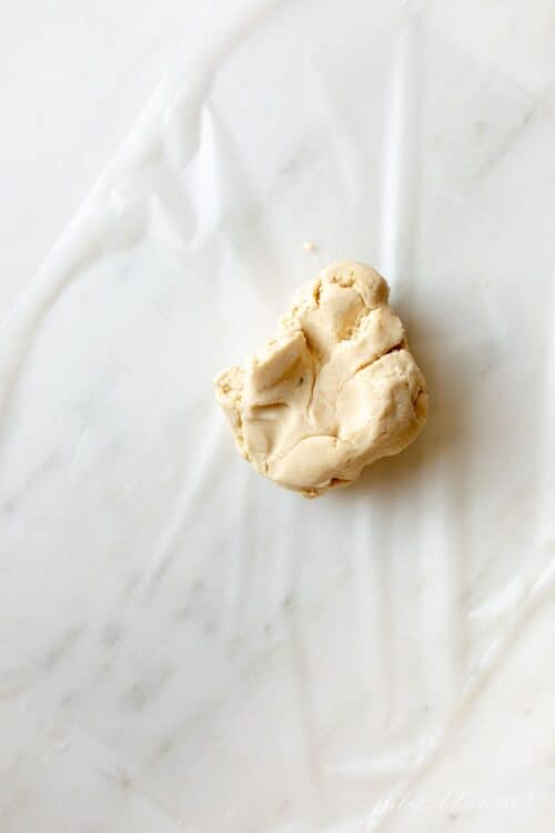 A ball of cookie dough on a marble surface