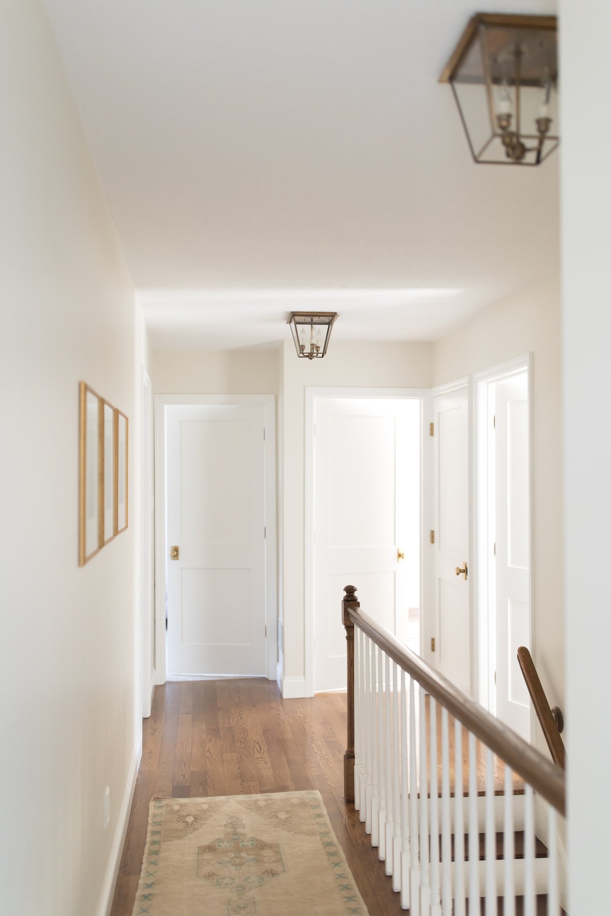 A hallway with white doors