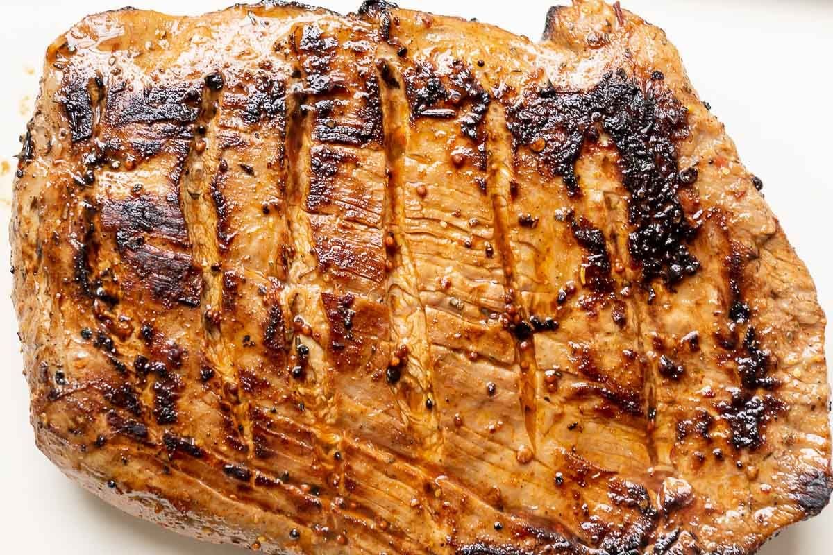 A close up of a cooked piece of steak.