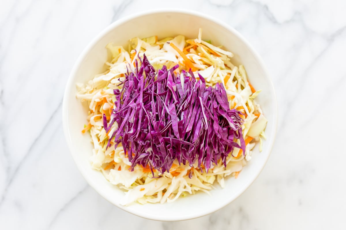A white bowl full of shredded cabbage.