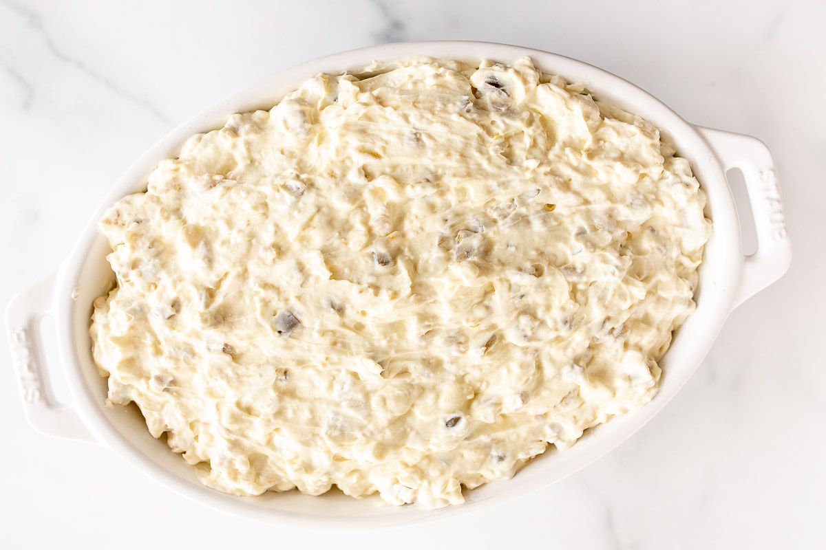 Creamy jalapeno dip on a marble countertop.