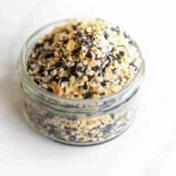 A small glass jar full of homemade everything bagel seasoning.