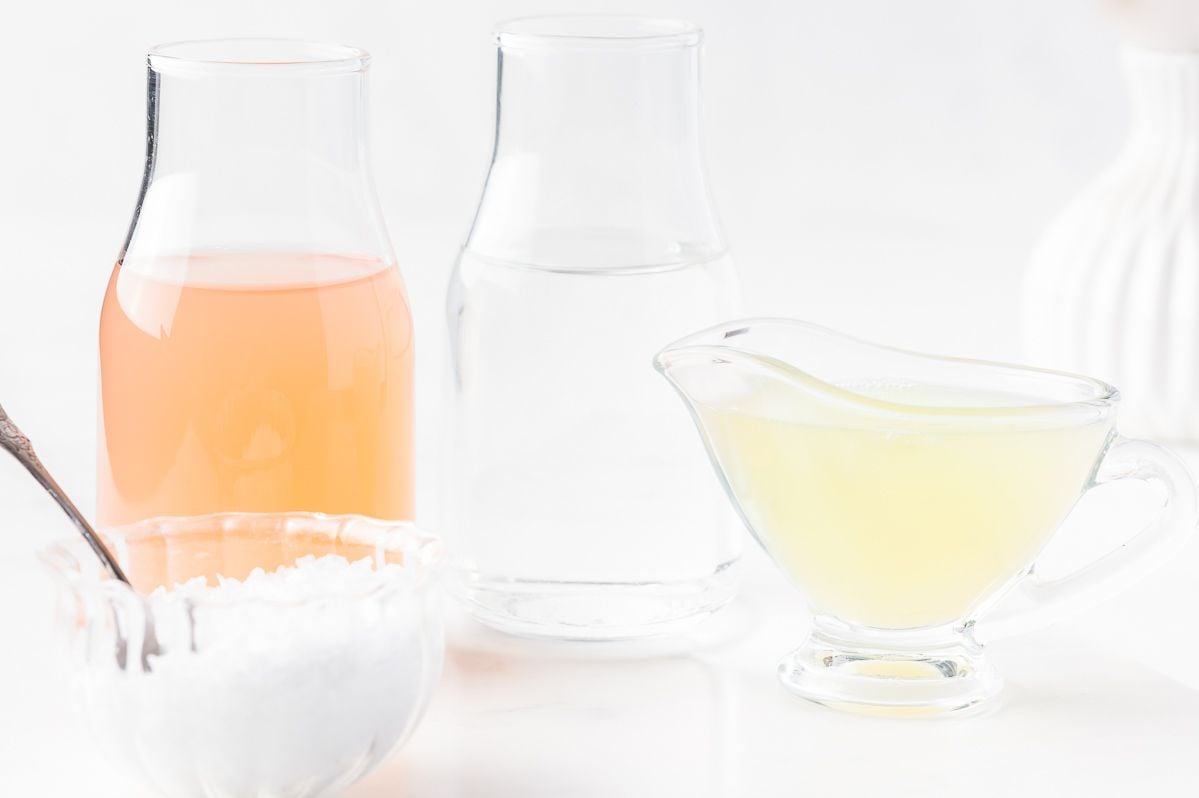 Ingredients for a paloma cocktail laid out on a marble surface