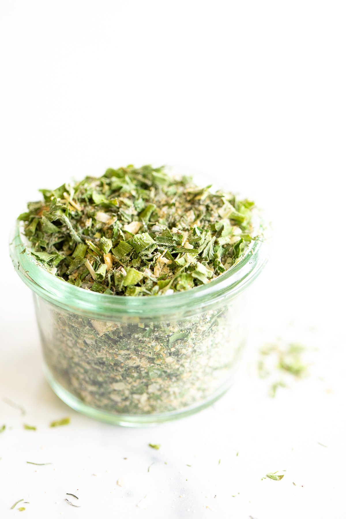 Glass jar of homemade ranch seasoning on a white countertop. 