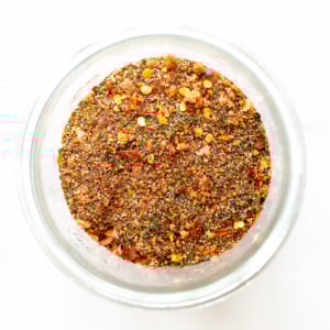 A glass jar with a mixture of the best steak seasoning in it.