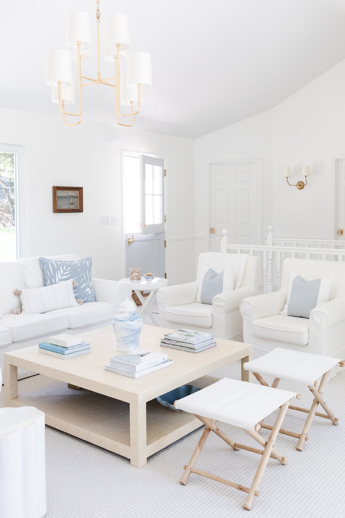 A white living room with white furniture for a vacation vibe at home.