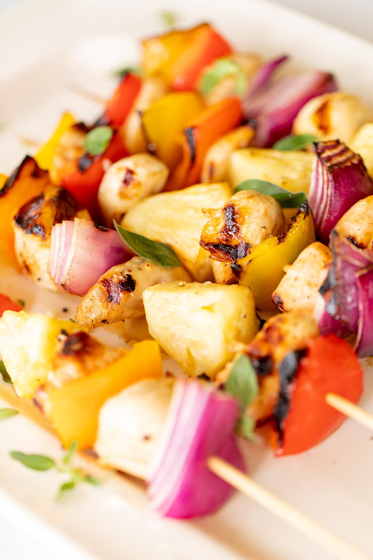 chicken kabobs on a white platter