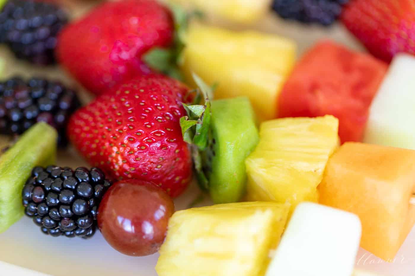 Close up of colorful fruit kebobs.