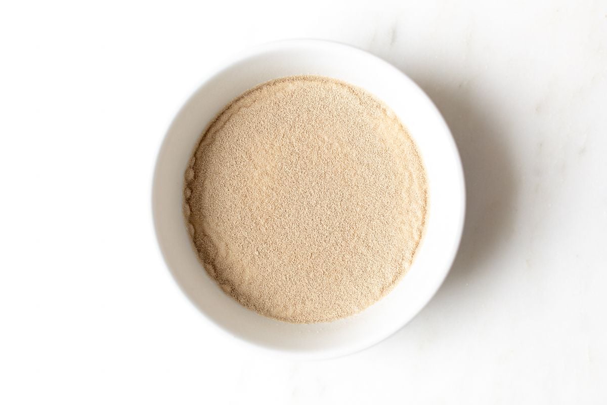 Yeast and milk in a white bowl.