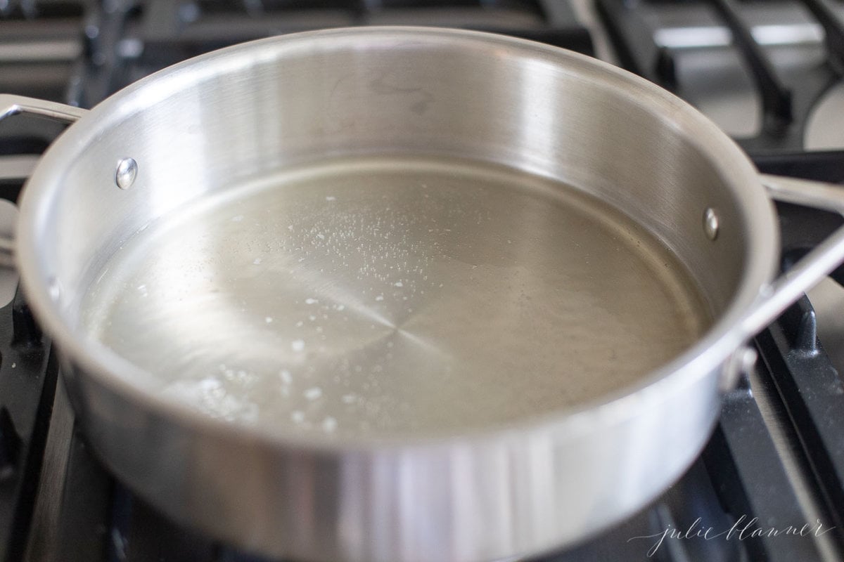 A stainless steel pan filled with a white wine lemon caper sauce.