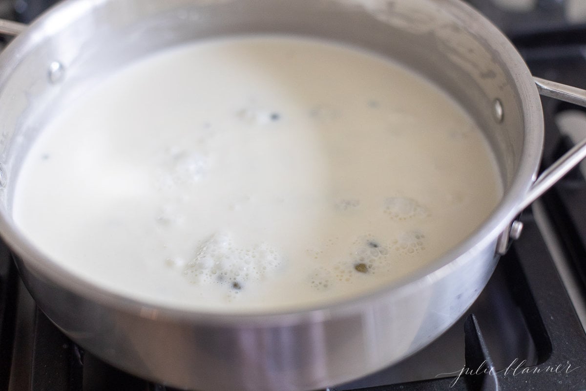 A stainless steel pan filled with a white wine lemon caper sauce.