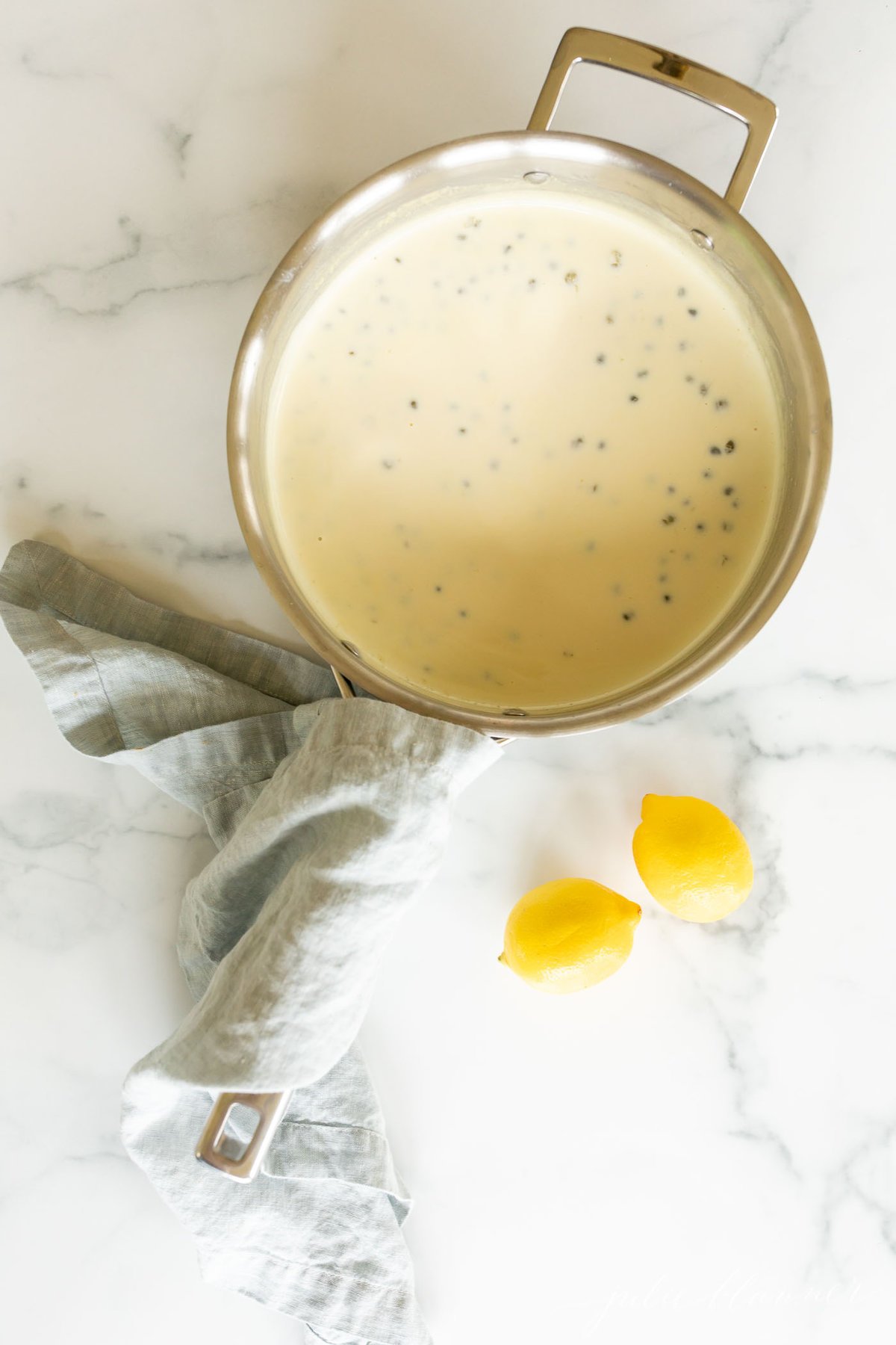 A stainless steel pan filled with a white wine lemon caper sauce.