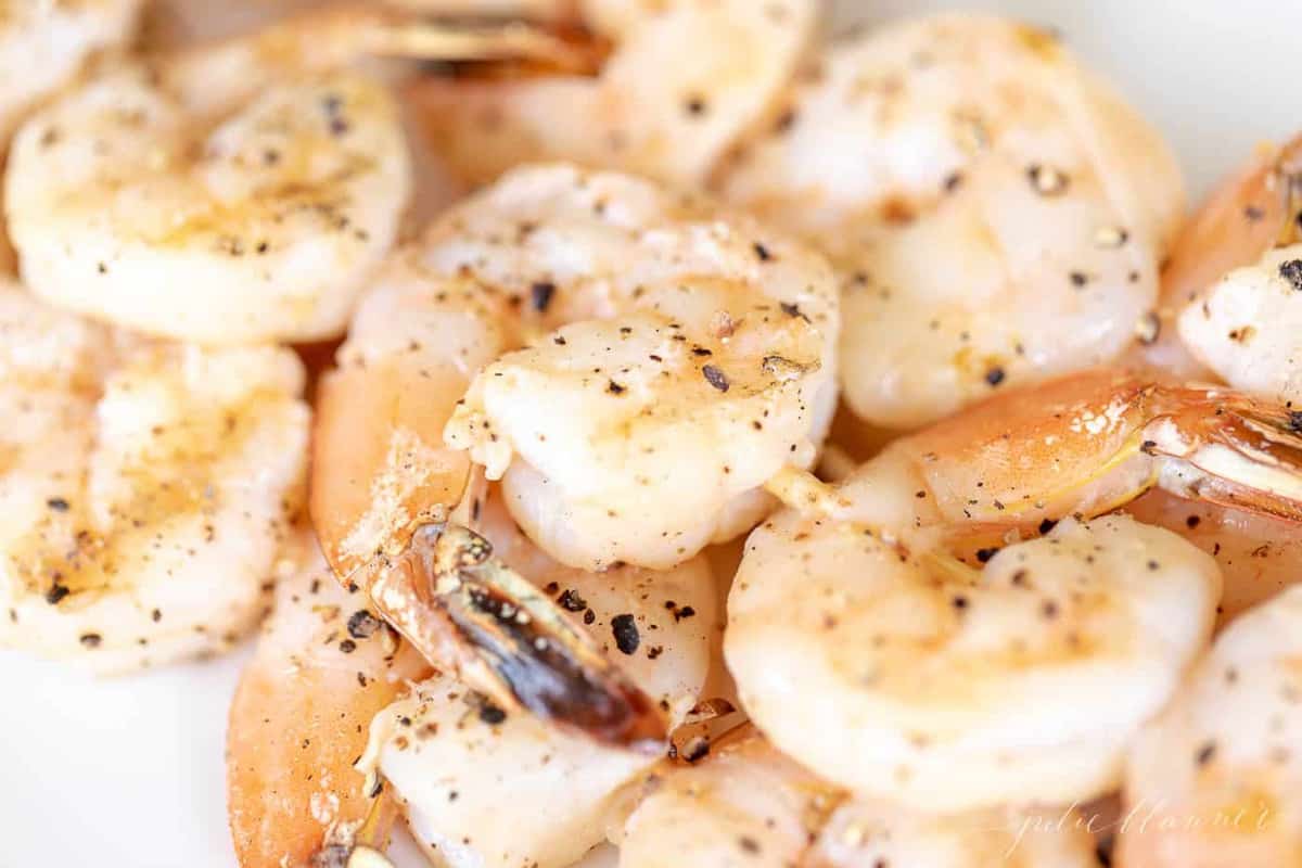 Close up of lemon garlic shrimp kabobs on bamboo skewers.