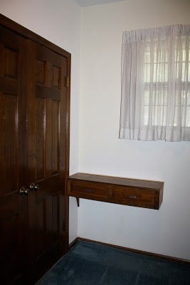 Old closet with dark wood doors.