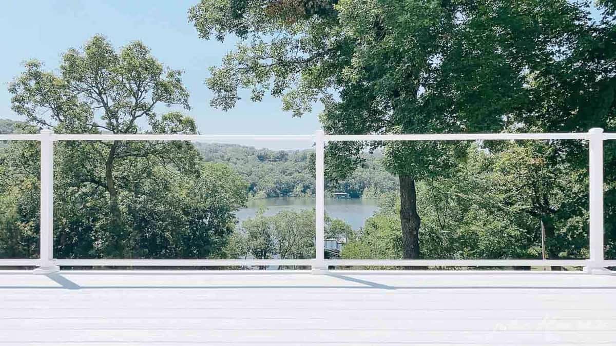 White vinyl decking with a lake view in background.