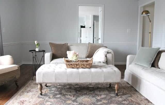 A neutral living room with walls painted in a soft gray called Sherwin Williams Rhinestone.