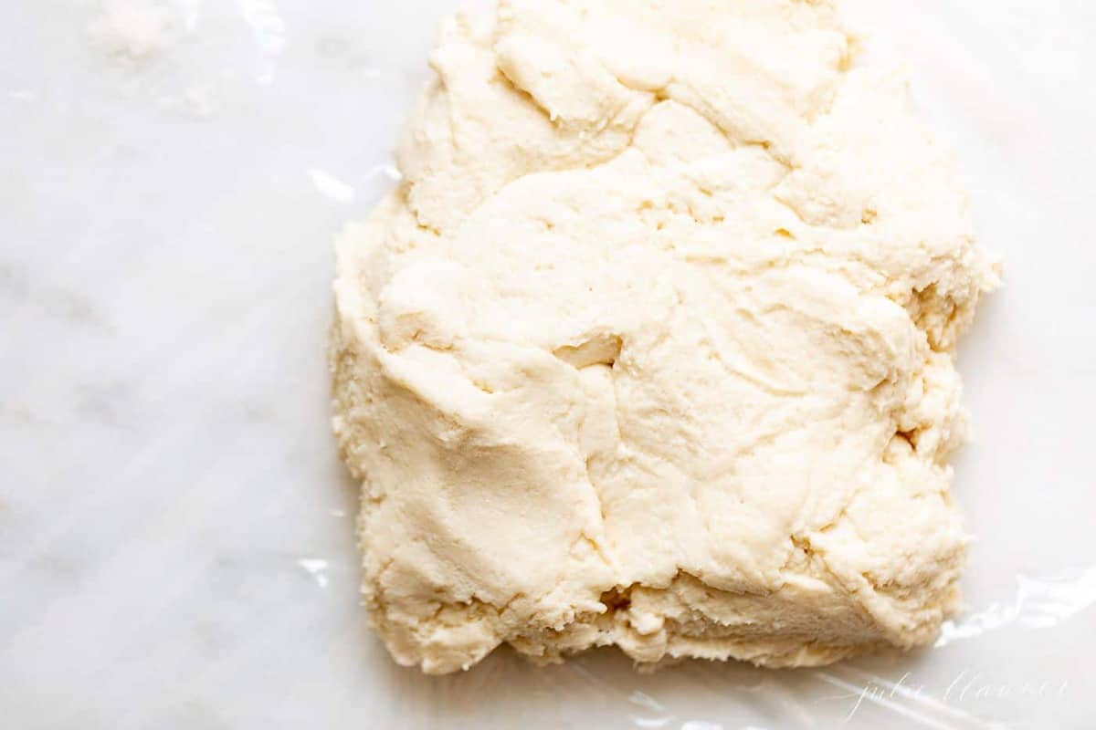 A chunk of easy pie crust on a white marble surface.