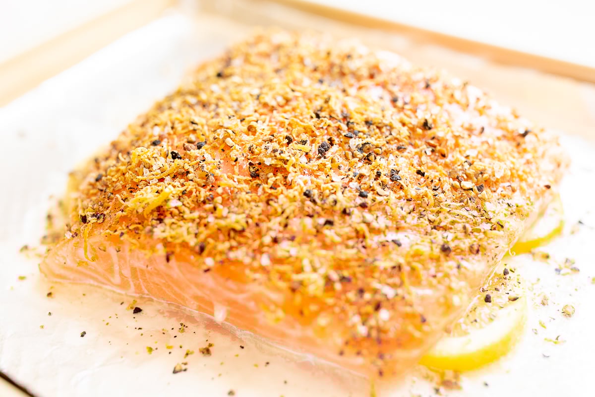 Lemon pepper salmon on a baking sheet.