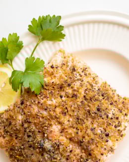 Lemon pepper salmon on a white platter.