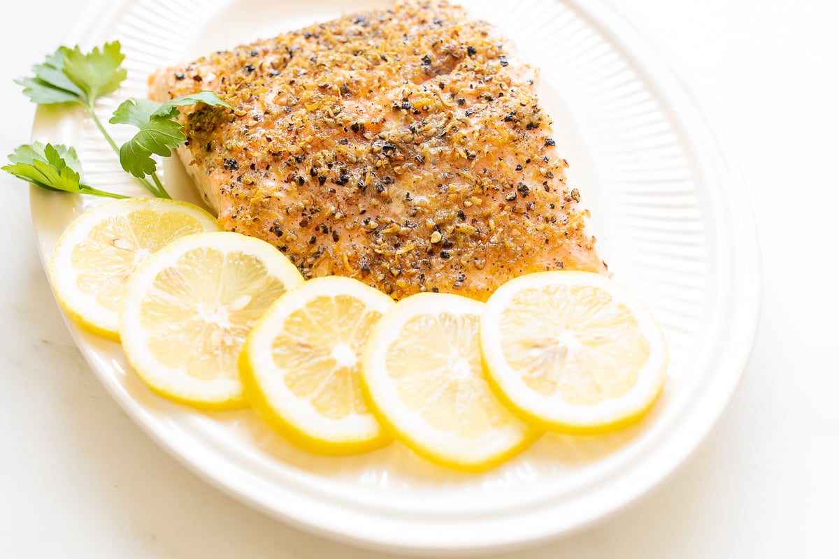 Lemon pepper salmon on a white platter.