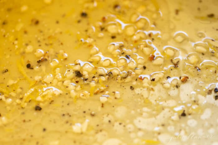 close up shot of lemon pepper sauce in a pan on a stove top