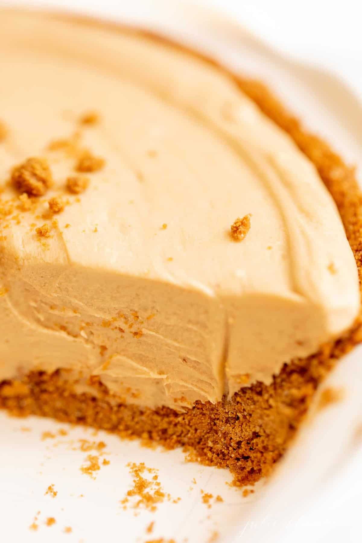 A cookie butter cheesecake with a speculoos cookie crust, slice removed.