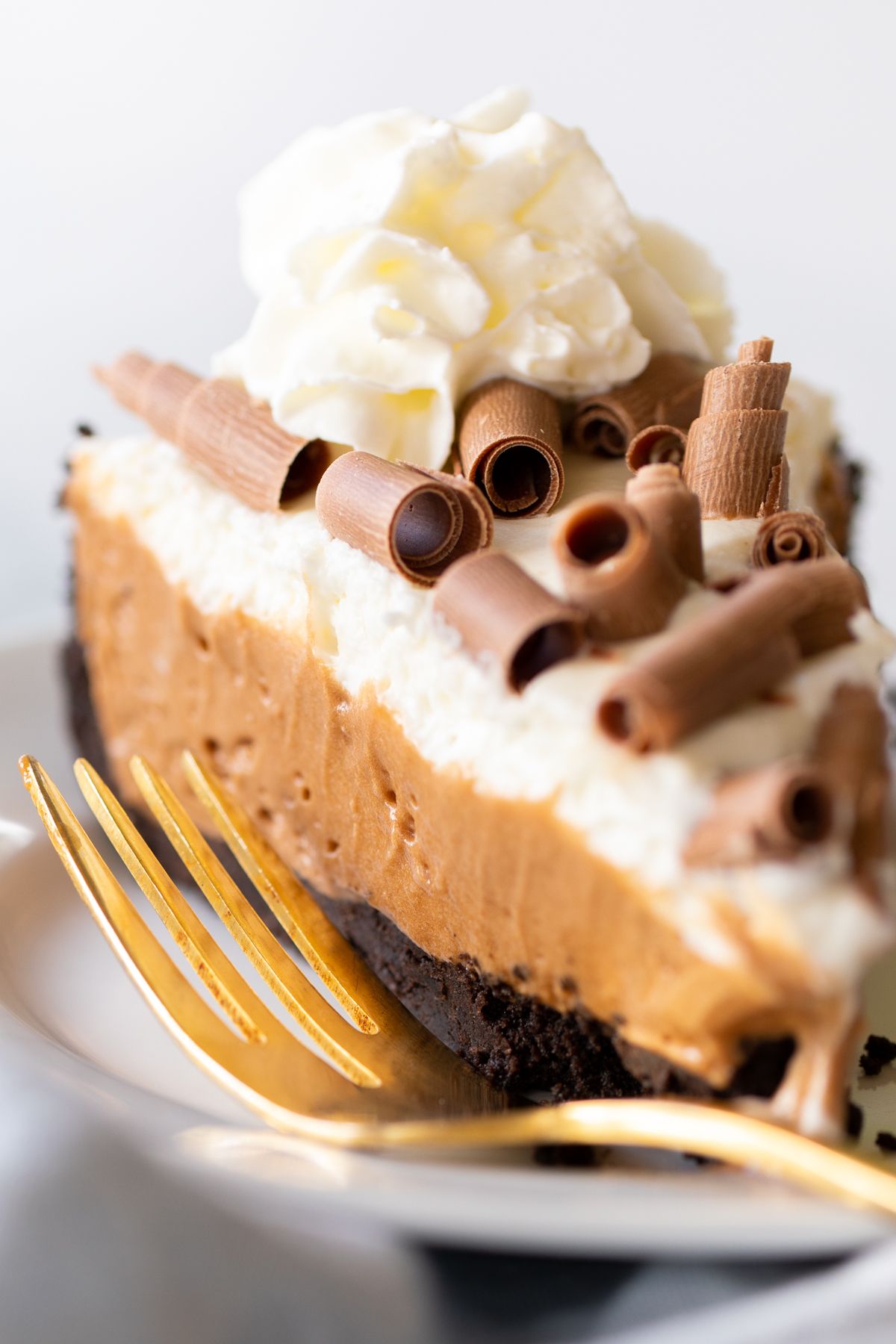 A slice of French silk pie on a white plate.