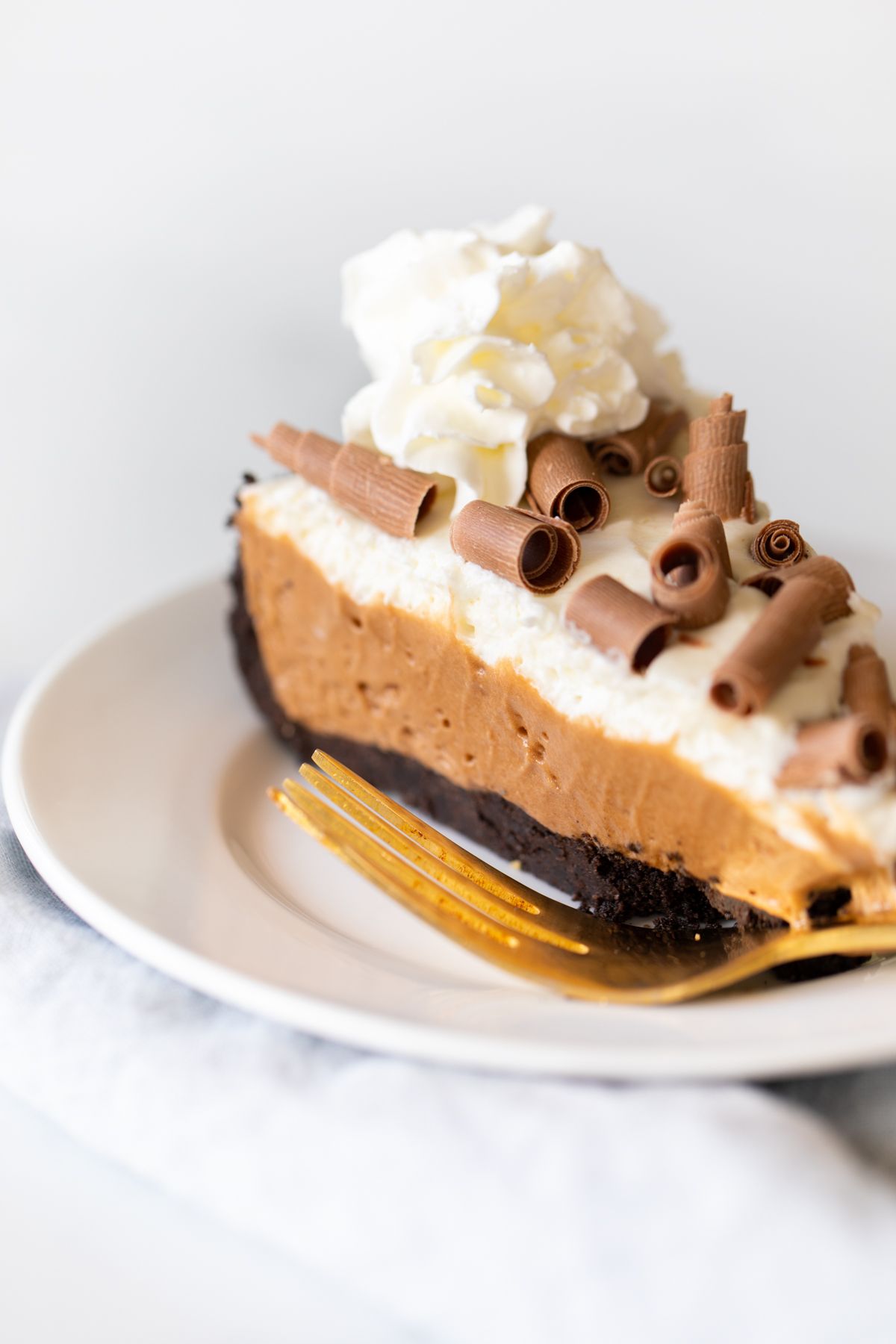 A slice of French silk pie on a white plate.