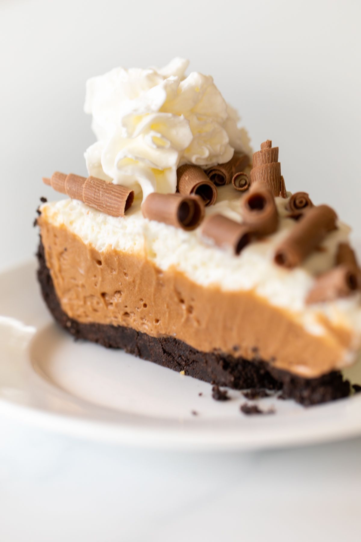 A slice of French silk pie on a white plate.