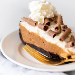 A slice of French silk pie on a white plate.