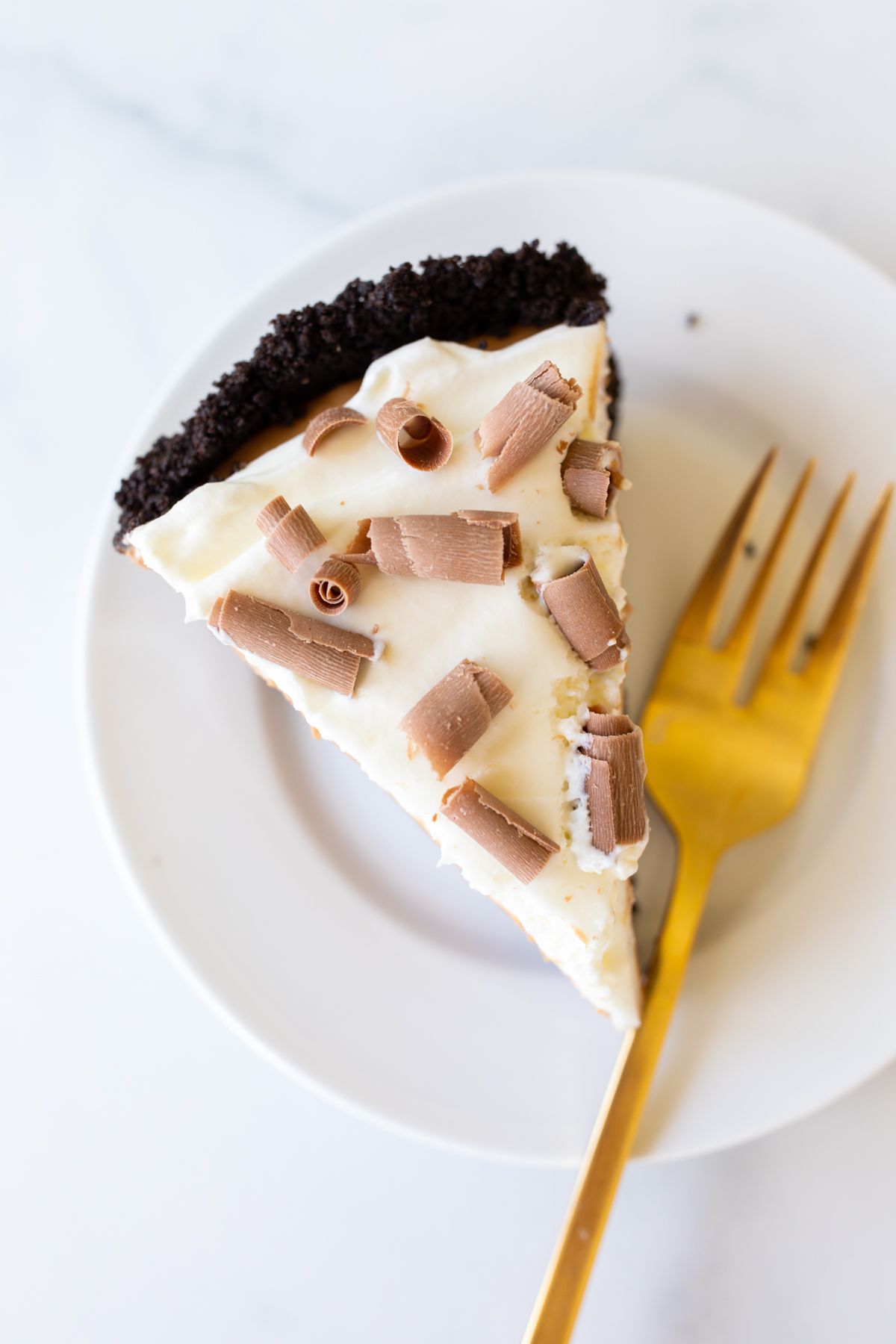 A slice of French silk pie on a white plate.