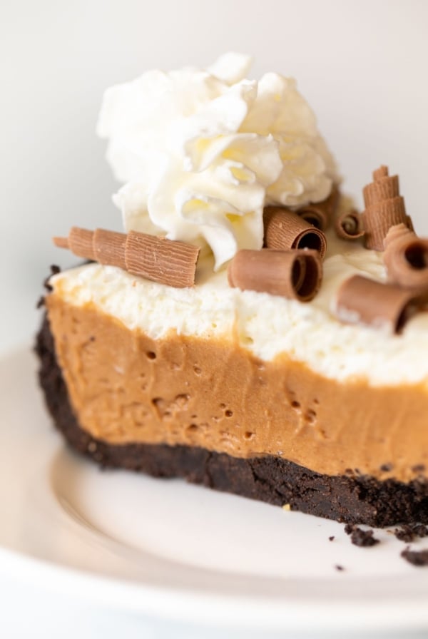 A slice of French silk pie on a white plate.