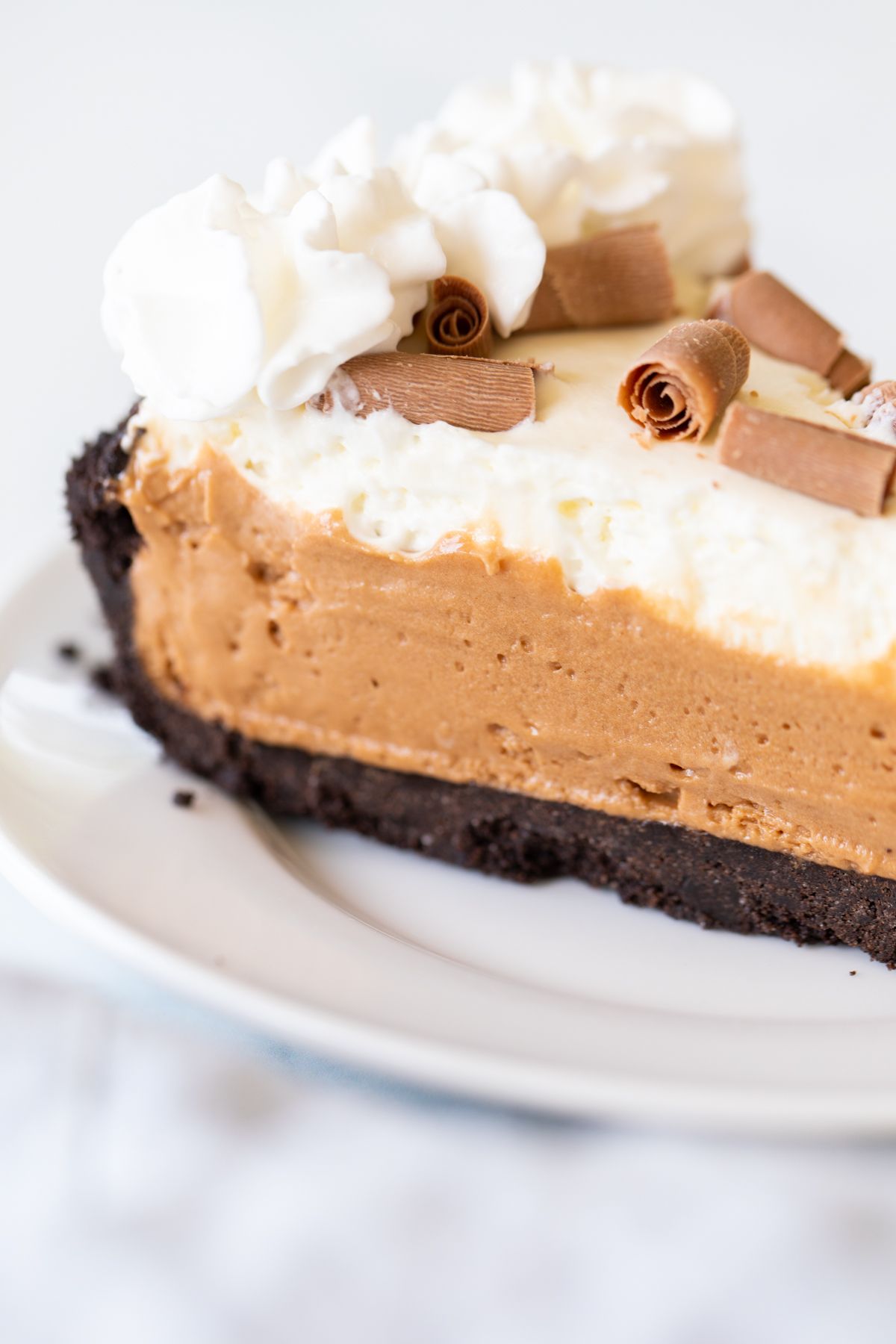 A slice of French silk pie on a white plate.