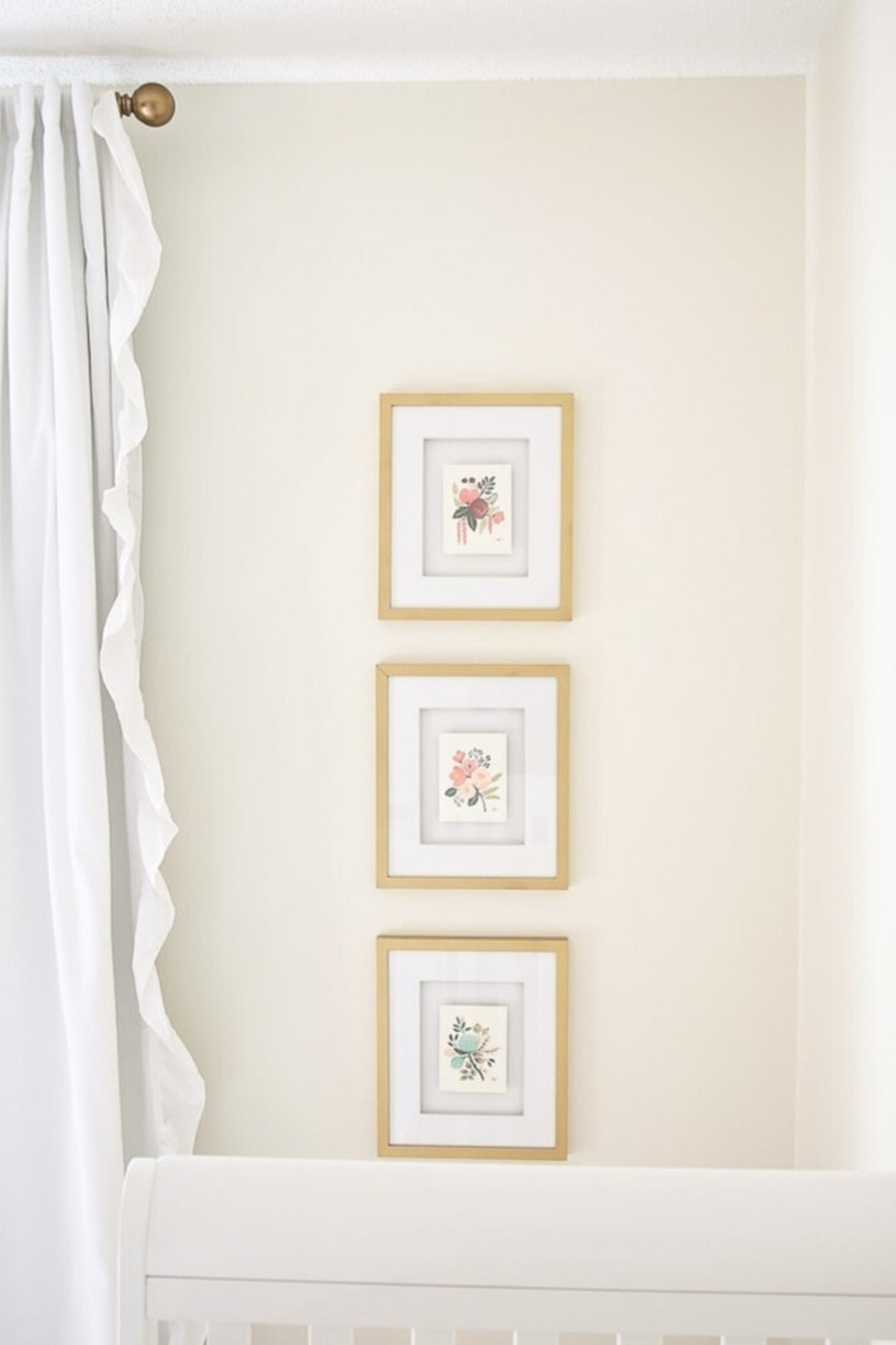 A DIY baby's nursery adorned with three framed pictures on the wall for personalized wall decor.
