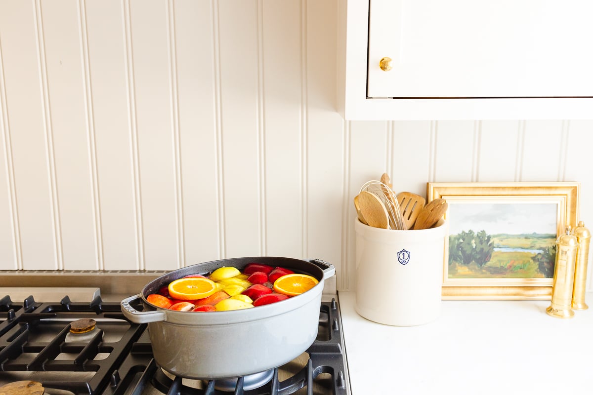 a white kitchen with homemade apple cider in a gray Dutch oven