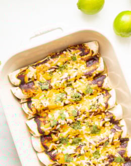 A white pan full of beef enchiladas.