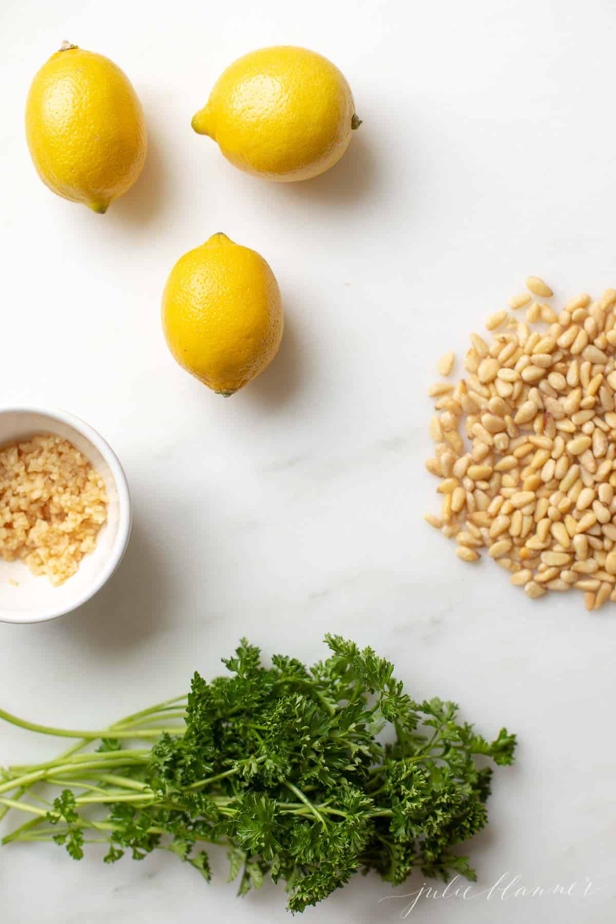 INGREDIENTS FOR GREMOLATA ON A MARBLE COUNTERTOP