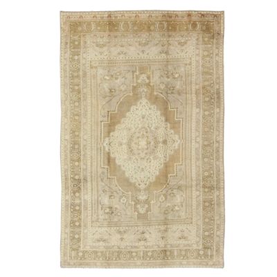 A vintage Turkish rug on a white background.