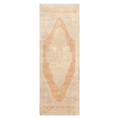 A vintage Turkish rug on a white background.