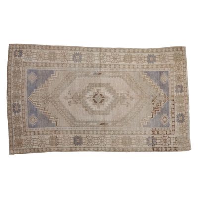 A vintage Turkish rug on a white background.