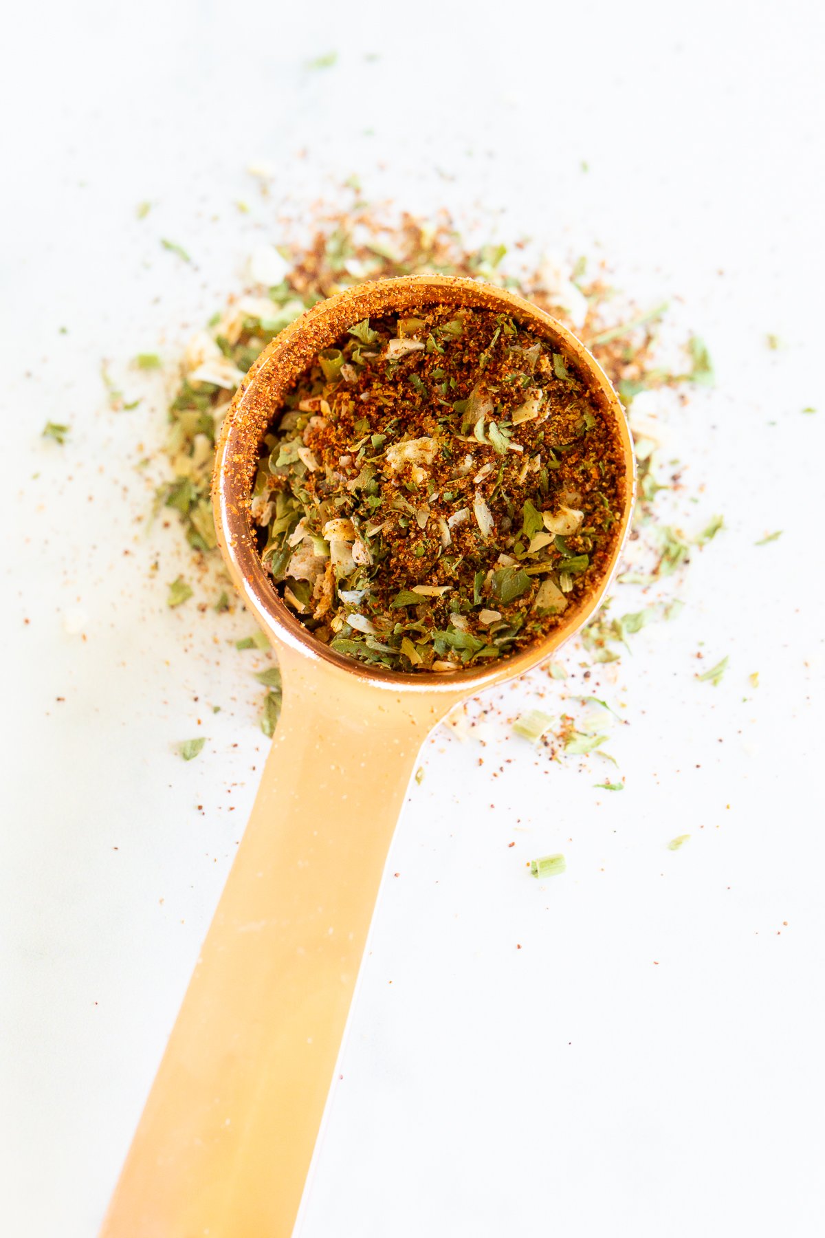 Homemade fiesta ranch seasoning in a copper measuring spoon.