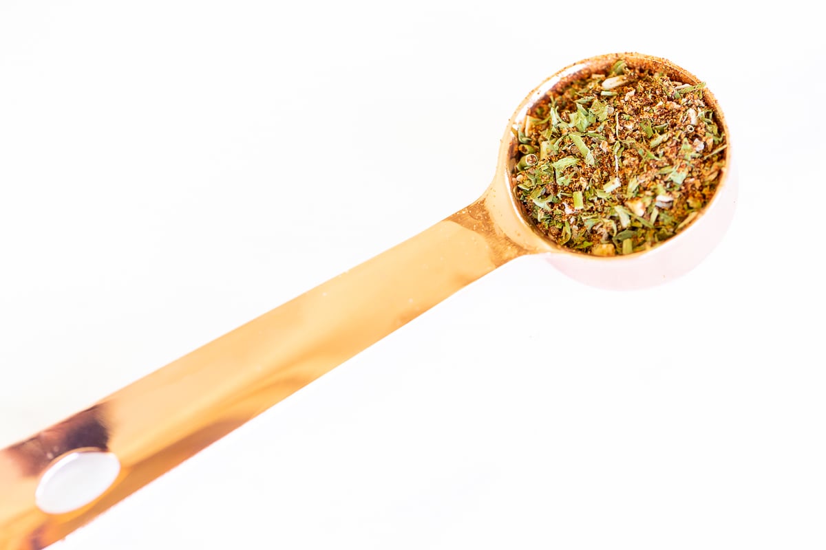 Homemade fiesta ranch seasoning in a copper measuring spoon.