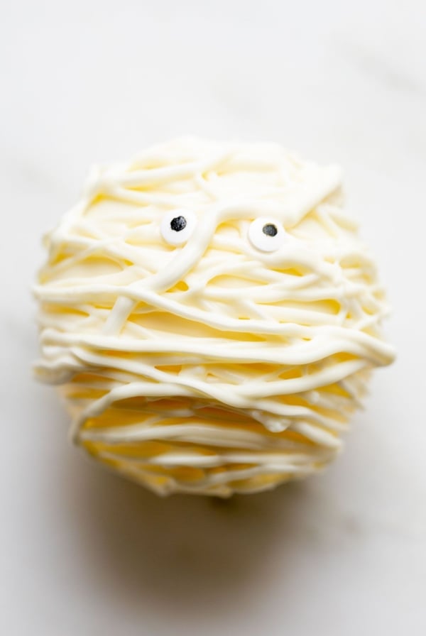 A white chocolate Halloween hot chocolate bomb, decorated as a mummy.