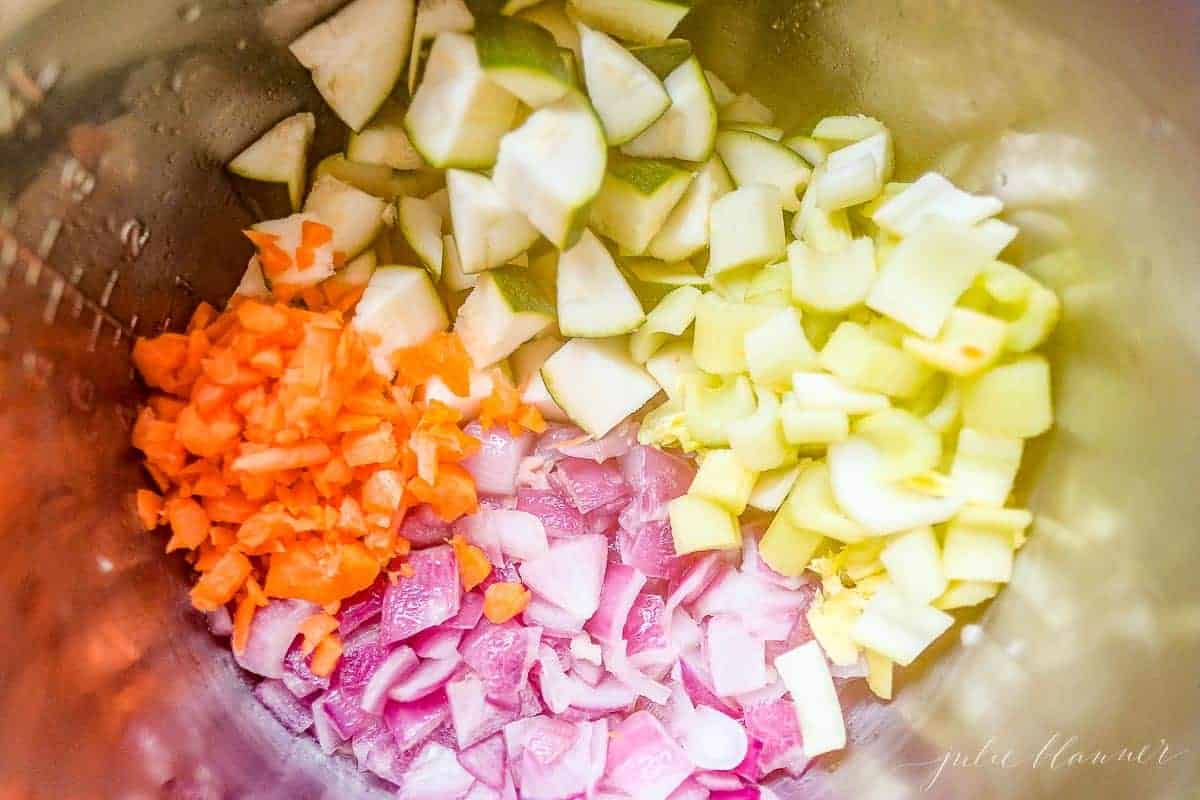 Looking into a pot full of cut vegetables for a minestrone soup recipe.